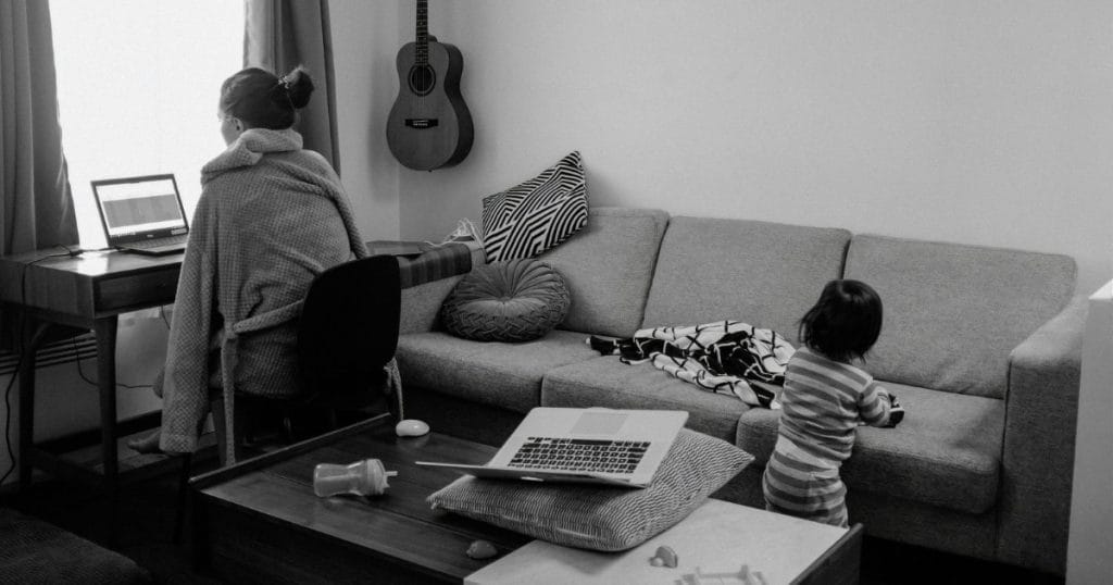 Content Creator with kid playing in behind - Image by Charles Deluvio